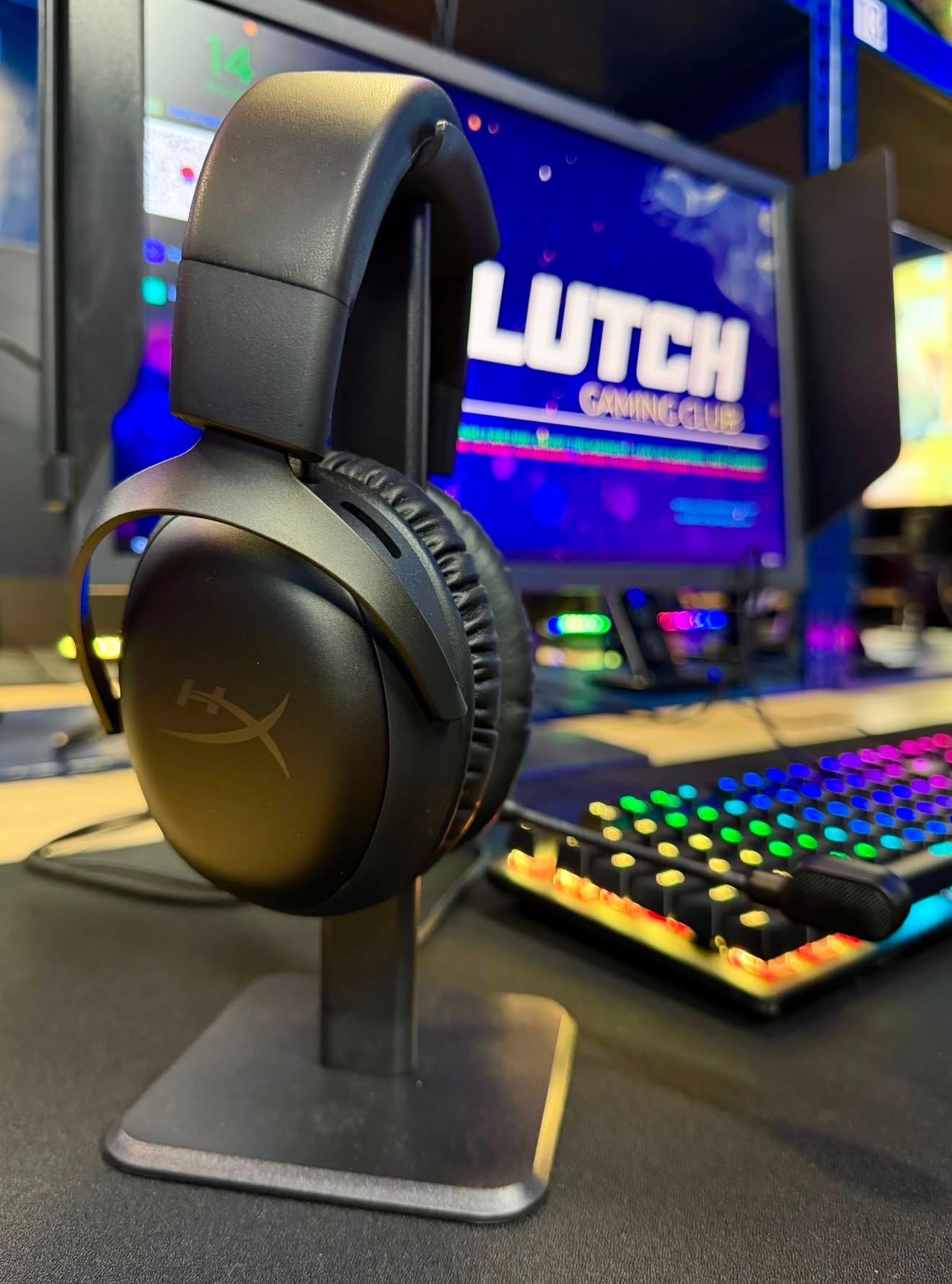 HyperX gaming headset beside an RGB keyboard