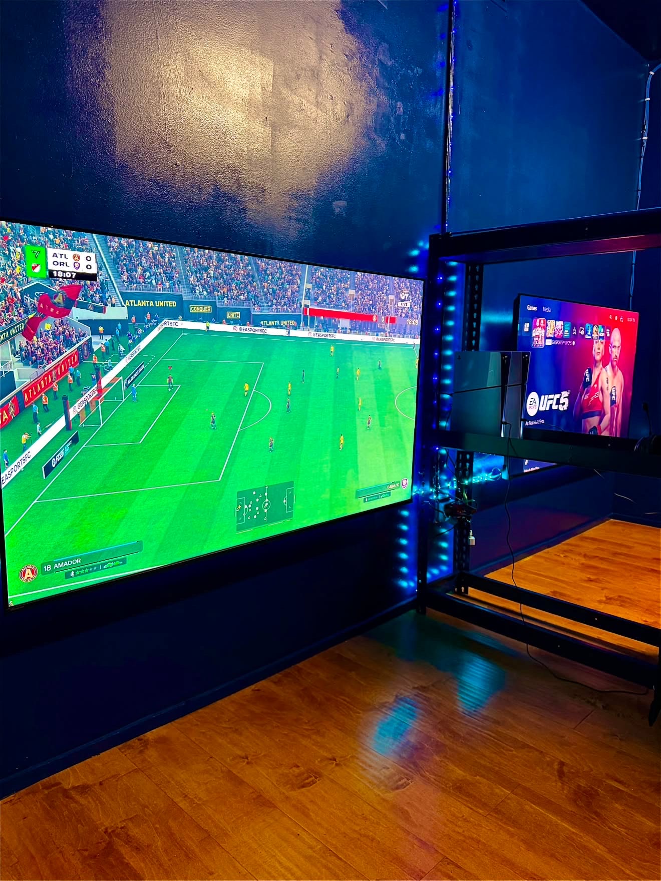 Two large console gaming screens inside Clutch Gaming Club