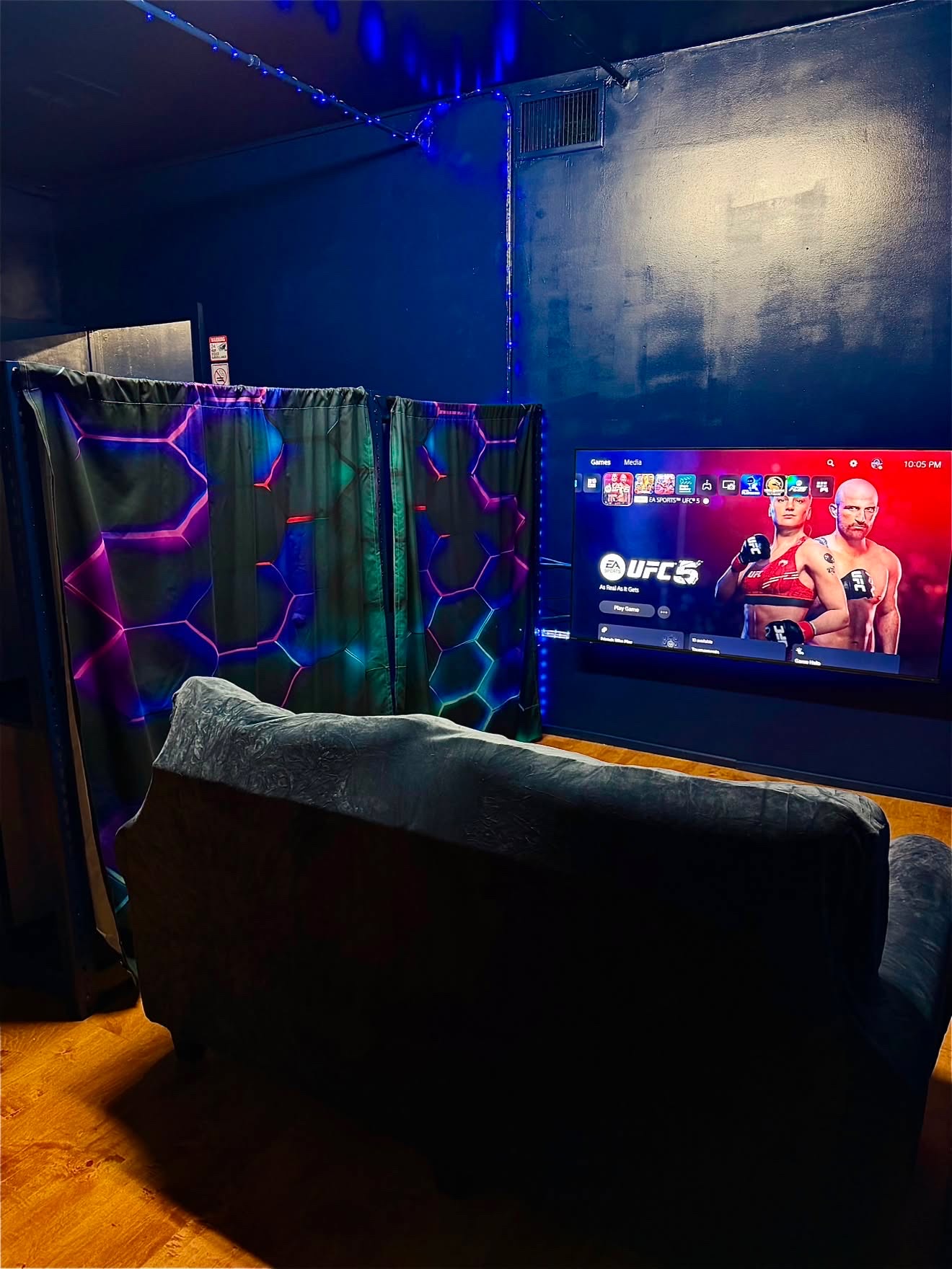 Private PS5 lounge showing a fighting game